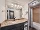Bathroom with granite countertop, large mirror, and tub at 3351 S Monaco Pkwy # F, Denver, CO 80222