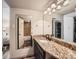 Bathroom features granite countertop, double sinks, and a tub at 3351 S Monaco Pkwy # F, Denver, CO 80222