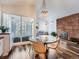 Modern dining area with glass table and four chairs, adjacent to kitchen at 3351 S Monaco Pkwy # F, Denver, CO 80222