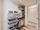 Well-organized laundry room with shelving and storage at 3351 S Monaco Pkwy # F, Denver, CO 80222