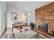 Living area features a fireplace and sliding glass doors to balcony at 3351 S Monaco Pkwy # F, Denver, CO 80222