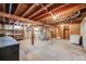 Unfinished basement with laundry hookups and storage shelving at 401 S Oak St, Lakewood, CO 80226