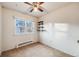 Simple bedroom with carpet, a ceiling fan, and built-in shelving at 401 S Oak St, Lakewood, CO 80226