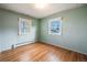 Spacious bedroom with hardwood floors and two windows at 401 S Oak St, Lakewood, CO 80226