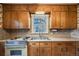 View of a retro kitchen with wood cabinets and a double sink at 401 S Oak St, Lakewood, CO 80226