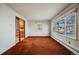 Spacious living room with large windows and brown carpet at 401 S Oak St, Lakewood, CO 80226