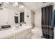 Well-lit bathroom featuring a tub, shower, and vanity with modern fixtures and decor at 9995 E Harvard Ave # 224, Denver, CO 80231