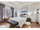 Bright bedroom featuring a large window, hardwood floors, and stylish accents at 9995 E Harvard Ave # 224, Denver, CO 80231