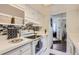 Well-lit kitchen with white cabinets, tiled backsplash, and modern appliances at 9995 E Harvard Ave # 224, Denver, CO 80231