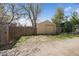 Detached garage with a wooden fence, situated in a quiet neighborhood at 1705 W Stoll Pl, Denver, CO 80221
