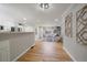 Open living space featuring hardwood floors and a view of the kitchen and secondary living space at 1705 W Stoll Pl, Denver, CO 80221