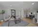 Cozy living room features hardwood floors, modern decor, and seamlessly connects to the dining area at 1705 W Stoll Pl, Denver, CO 80221