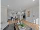 Open-concept living area with hardwood floors connecting dining and kitchen, perfect for entertaining and Gathering gatherings at 1705 W Stoll Pl, Denver, CO 80221
