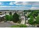 Wide aerial view showcases a tree-lined neighborhood and nearby city amenities at 1231 W Radcliff Ave, Englewood, CO 80110