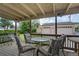 Back porch with a full patio set connected to a detached garage and backyard at 1231 W Radcliff Ave, Englewood, CO 80110