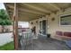 Back porch with a patio set, grill, and sliding glass door access to the interior of the home at 1231 W Radcliff Ave, Englewood, CO 80110