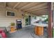Back porch with patio furniture and grilling station connected to the backyard at 1231 W Radcliff Ave, Englewood, CO 80110