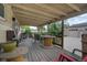 Back porch with outdoor dining and patio furniture, connected to the backyard and garage at 1231 W Radcliff Ave, Englewood, CO 80110