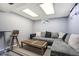 Finished basement with a large sectional couch, coffee table, and a bar table with a chair at 1231 W Radcliff Ave, Englewood, CO 80110