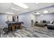 Finished basement with pool table, lounge area, and stylish flooring at 1231 W Radcliff Ave, Englewood, CO 80110