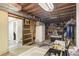 Unfinished basement used for storage with a refrigerator and access to the upper level at 1231 W Radcliff Ave, Englewood, CO 80110