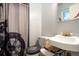 Bathroom featuring a Harley Davidson themed shower curtain and toilet seat at 1231 W Radcliff Ave, Englewood, CO 80110
