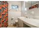 Bright bathroom with a single sink, vanity, and fun shower curtain at 1231 W Radcliff Ave, Englewood, CO 80110