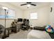 Cozy bedroom featuring a ceiling fan, natural light, and a dedicated workspace at 1231 W Radcliff Ave, Englewood, CO 80110