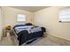 A clean bedroom with two windows and light-colored walls at 1231 W Radcliff Ave, Englewood, CO 80110