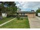 Charming single-story home with an attached garage and mature tree in a well-maintained front yard at 1231 W Radcliff Ave, Englewood, CO 80110