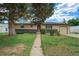 Charming single-story home with an attached garage and mature tree in a well-maintained front yard at 1231 W Radcliff Ave, Englewood, CO 80110