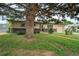 Charming single-story home with an attached garage and mature tree in a well-maintained front yard at 1231 W Radcliff Ave, Englewood, CO 80110