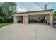 A detached multi-car garage with ample parking space on a paved driveway and filled with motorcycles at 1231 W Radcliff Ave, Englewood, CO 80110