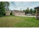 View of the spacious garage with a manicured lawn, complemented by an additional storage shed at 1231 W Radcliff Ave, Englewood, CO 80110