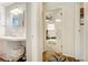 Hallway view into bathroom and bedroom with carpet and hardwood flooring at 1231 W Radcliff Ave, Englewood, CO 80110