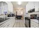 Galley kitchen leading to a dining area at 1231 W Radcliff Ave, Englewood, CO 80110