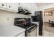 A galley style kitchen with stove and refrigerator at 1231 W Radcliff Ave, Englewood, CO 80110
