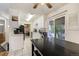 Galley style kitchen with tiled floors and sliding door to the deck at 1231 W Radcliff Ave, Englewood, CO 80110