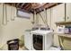 Bright laundry room with modern washer and dryer, as well as shelving at 1231 W Radcliff Ave, Englewood, CO 80110