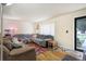 Comfortable living room with hardwood floors, stylish furniture, and bright window at 1231 W Radcliff Ave, Englewood, CO 80110