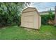 Tan shed surrounded by lush landscaping, offering practical outdoor storage at 1231 W Radcliff Ave, Englewood, CO 80110