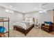 Finished basement bedroom with wood bed frame and sitting area at 551 E Caley Dr, Centennial, CO 80121