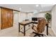 Finished basement office with L-shaped desk and barn door at 551 E Caley Dr, Centennial, CO 80121