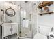 Updated bathroom with a walk-in shower, white vanity, and stylish shelves at 551 E Caley Dr, Centennial, CO 80121