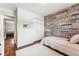 Bright bedroom with wood-like accent wall and hardwood floors at 551 E Caley Dr, Centennial, CO 80121