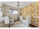 Charming bedroom with a unique wallcovering, and plenty of natural light at 551 E Caley Dr, Centennial, CO 80121