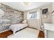 Cozy bedroom with wood floors, accent wall, and plenty of natural light at 551 E Caley Dr, Centennial, CO 80121