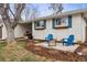 Cozy front yard with fire pit and blue Adirondack chairs at 551 E Caley Dr, Centennial, CO 80121