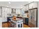 Modern kitchen with copper sink, stainless steel appliances, and custom island at 551 E Caley Dr, Centennial, CO 80121