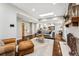 Open living room featuring hardwood floors, a fireplace, and a view into the kitchen at 551 E Caley Dr, Centennial, CO 80121